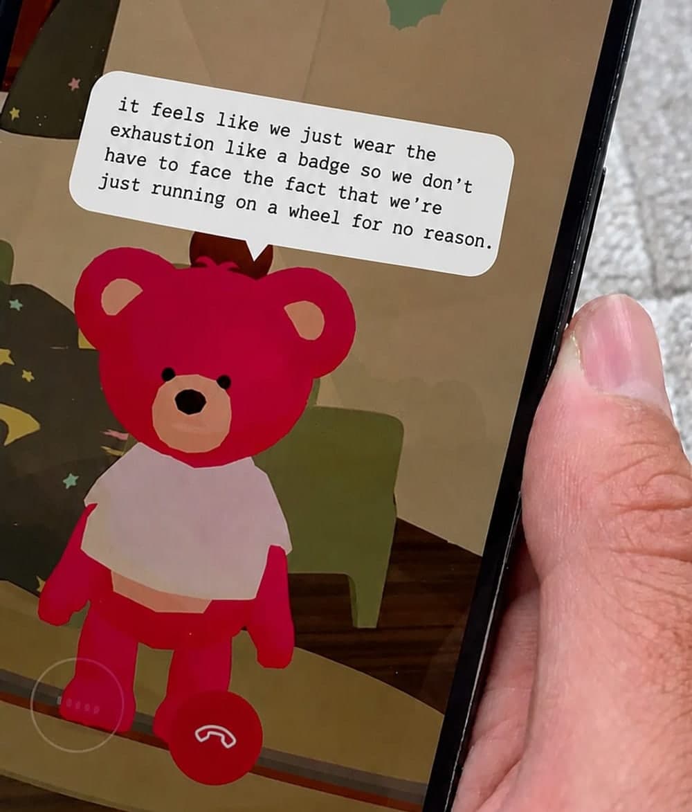A phone held in one hand, mid-call with Ted, the bear speaking on screen